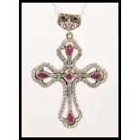 A silver pendant necklace having a large Gothic style crucifix pendant set with cubic zirconia and