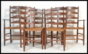 A set of six early 20th Century oak ladder back dining chairs having rattan weave seats raised on