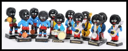 A collection of Robertson jam Golly figures to include a guitar player, football players, a rugby