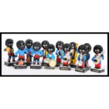 A collection of Robertson jam Golly figures to include a guitar player, football players, a rugby