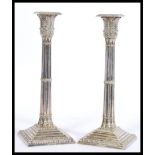 A pair of Mappin & Webb silver plated candlesticks having square stepped bases with moulded