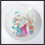 An 18th century Chinese porcelain charger plate of large size having hand painted central panel