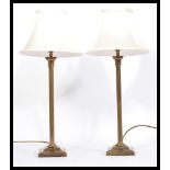 A pair of 20th Century matching brass column table lamps, of Corinthian column form raised on a