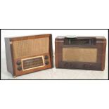 Two 1940's walnut cased valve radios, each with decorative facia and dials, one in light walnut, the
