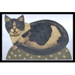 A 20th century carved wooden panel painting of a cat on domed floral base. Hand painted with