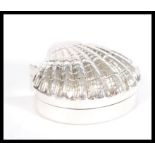 A stamped 925 silver trinket box in the form of a shell. Weight 29.4g. 2cm- high 5cm- wide.