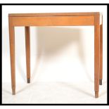 A mid 20th century century beech wood Air Ministry type writing table desk being raised on square
