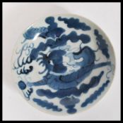 A 19th Century Chinese blue and white dinner plate with hand painted decoration depicting a