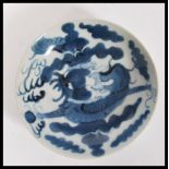 A 19th Century Chinese blue and white dinner plate with hand painted decoration depicting a