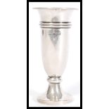 A silver hallmarked stem vase of trumpet form raised on a round base. Hallmarked Birmingham 1958.