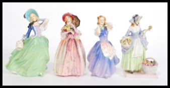 A group of four Royal Doulton figurines to include Betsy HN2111, June HN1691, Autumn Breezes