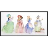 A group of four Royal Doulton figurines to include Betsy HN2111, June HN1691, Autumn Breezes