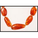 A 20th Century amber graduating beaded necklace set with a gilt lobster clasp.