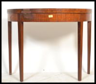 A 19th century George III mahogany demi lune tea table / games card table. Raised on square tapering