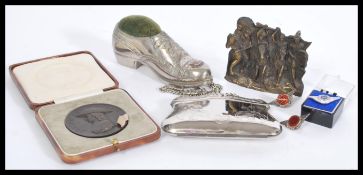 A collection of vintage items to include a silver plated pin cushion in the form of a shoe, boxed