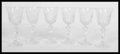 A boxed set of Bohemia Crystal cut glass wine glasses having a star cut design with bell shaped