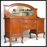 A 1920's oak mirror back sideboard. Raised on cabriole legs with pad feet supporting a bow fronted