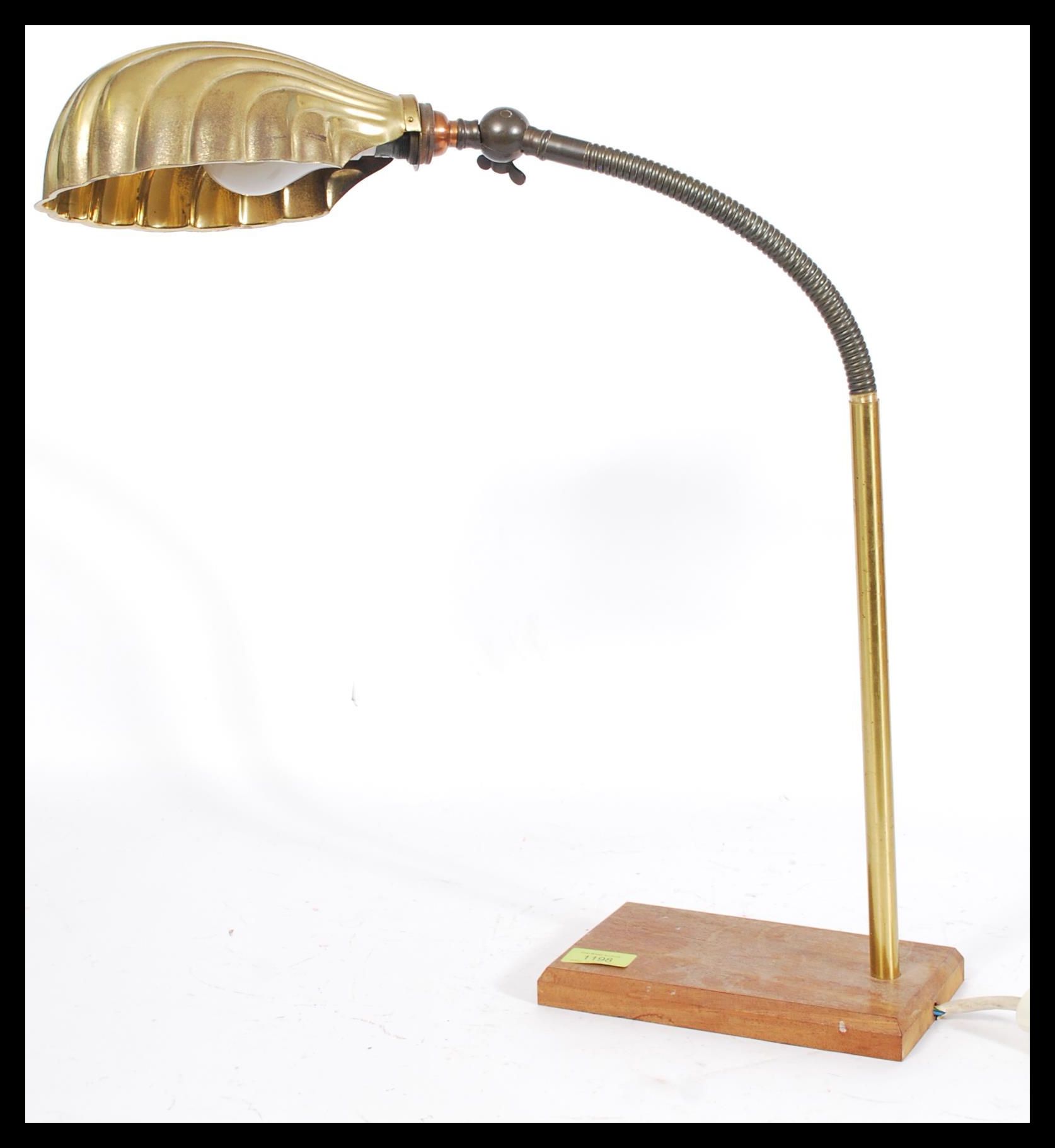 An early 20th century Industrial anglepoise brass lamp with goose neck adjustable neck, cast iron