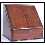 A Victorian mahogany desk tidy with twin doors opening to reveal a stationary sectional interior.