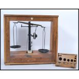 A vintage retro 20th century oak cased set of scientific apothecary weighing balance scales with