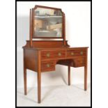 A  late 19th century satinwood dressing table by Shoolbred of London with swing mirror over an