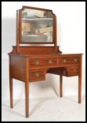 A  late 19th century satinwood dressing table by Shoolbred of London with swing mirror over an