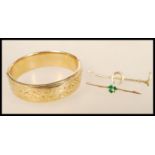 A vintage 1/5 th  9ct gold bangle bracelet with metal core together with two bar brooches