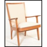 A retro 20th Century mahogany hardwood open framed armchair, raised on tapering supports having open