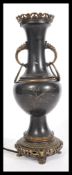 An early 20th century Japanese bronze table lamp raised on bronze socle base with twin handles