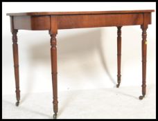 A Georgian 19th century mahogany console hall table being raised  on turned tapering legs with