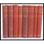 A set of eight Rudyard Kipling hard backed novels with red linen boards published by Macmillan &