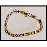 An Edwardian 15ct gold nautical alphabet flag and numerical pennant link bracelet, having 26 links