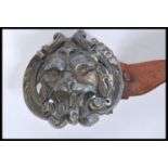 A vintage early 20th century leather belt having a