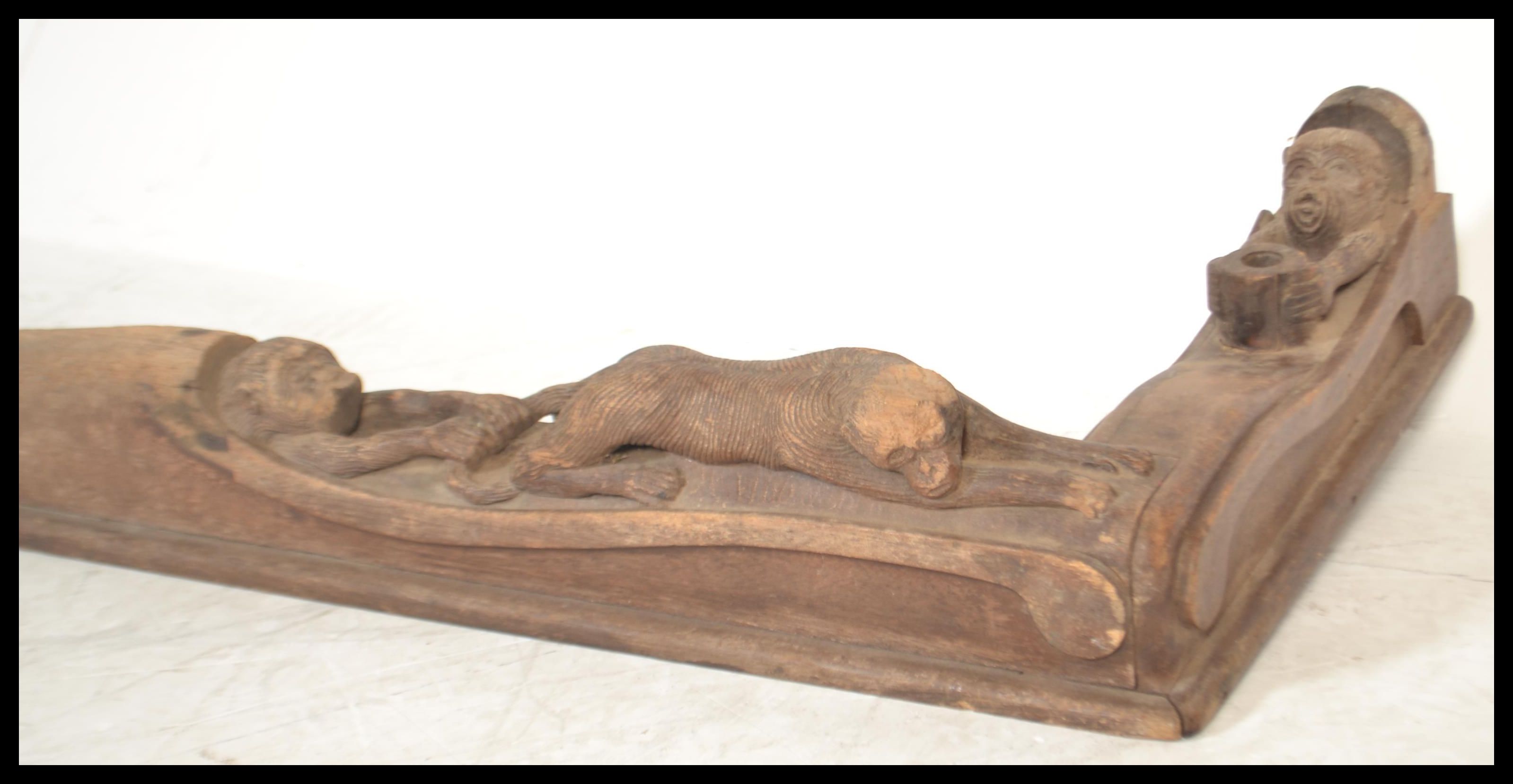 A vintage 20th Century carved oak fire fender kerb of African tribal inspiration, the fender heavily - Image 3 of 7