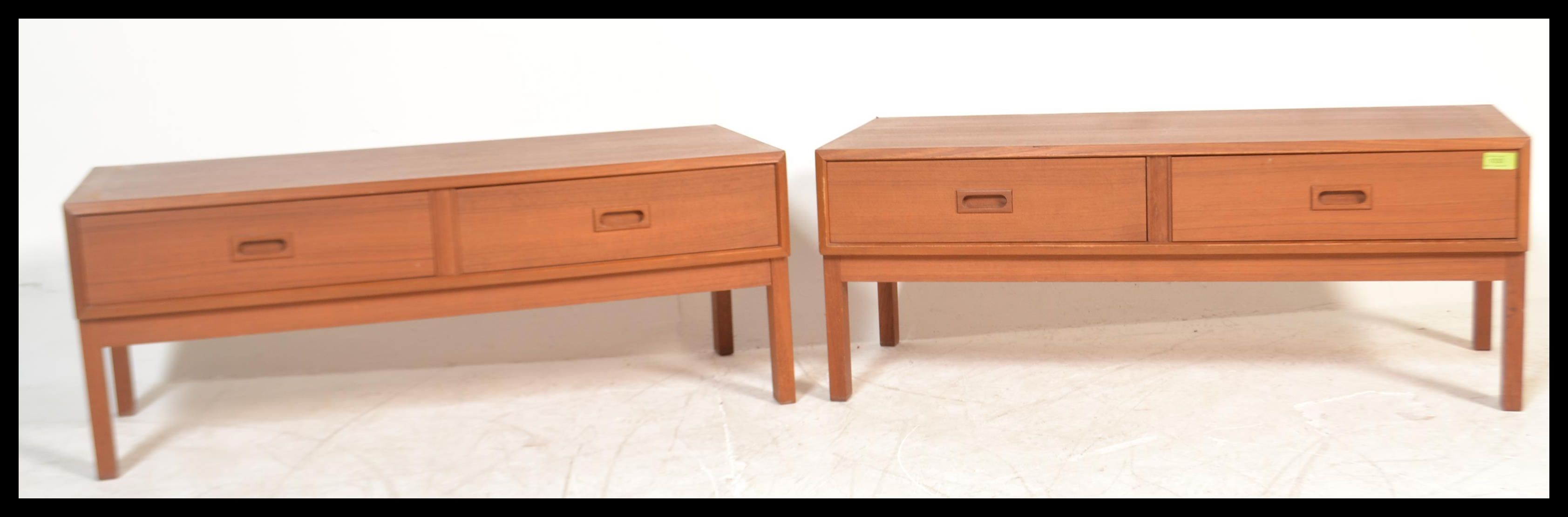 A pair of matching retro 20th Century teak wood Danish inspired low cabinets, each cabinet having