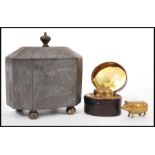 A 19th Century travelling hinged top inkwell cased with a red leather lining, a stunning brass pig