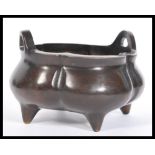 A 19th Century Chinese bronze censer ding bowl of bulbous segmented form raised on four stub feet