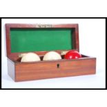 A 19th century Victorian mahogany cased set of 3 ivory snooker / Billiards balls. The case with