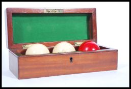 A 19th century Victorian mahogany cased set of 3 ivory snooker / Billiards balls. The case with