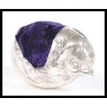 A silver pincushion in the form of a chick having a blue velvet cushion to the back. 4.5cm high 4.