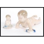 Two Royal Copenhagen figurines of Cherubs including a Piano Baby 1739 and a Mermaid 2313. Printed