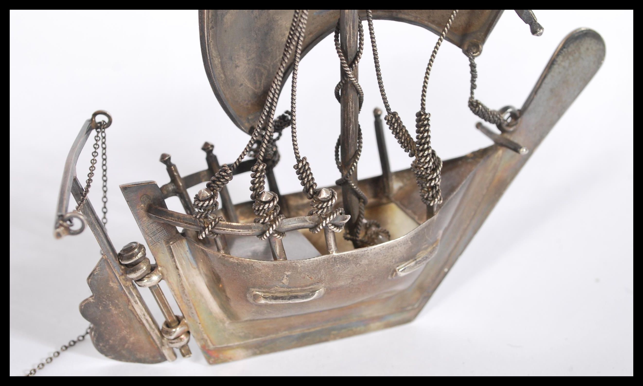 A silver / white metal model of a sailing box complete with sails moving bucket, rudder and ropes. - Image 3 of 4