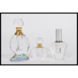 A group of three vintage 20th Century Art Deco style perfume scent bottles of faceted glass form.