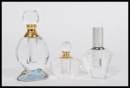 A group of three vintage 20th Century Art Deco style perfume scent bottles of faceted glass form.