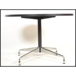 After Charles & Ray Eames - A contemporary round dining table. The table having a black finished oak