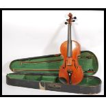 An early 20th Century violin musical instrument having a two piece maple back and spruce front.