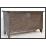 An 18th century carved oak coffer chest / blanket box. The coffer with inverted carved stile