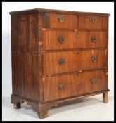 A 17th century walnut Queen Anne 2 part chest of drawers. The chest with pierced brass  handles