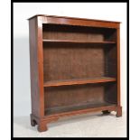 An Edwardian solid mahogany open window bookcase cabinet being raised on bracket feet with 3 shelves