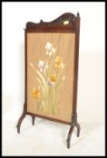 A Victorian 19th century mahogany Art Nouveau firescreen with tapestry centre being glazed and